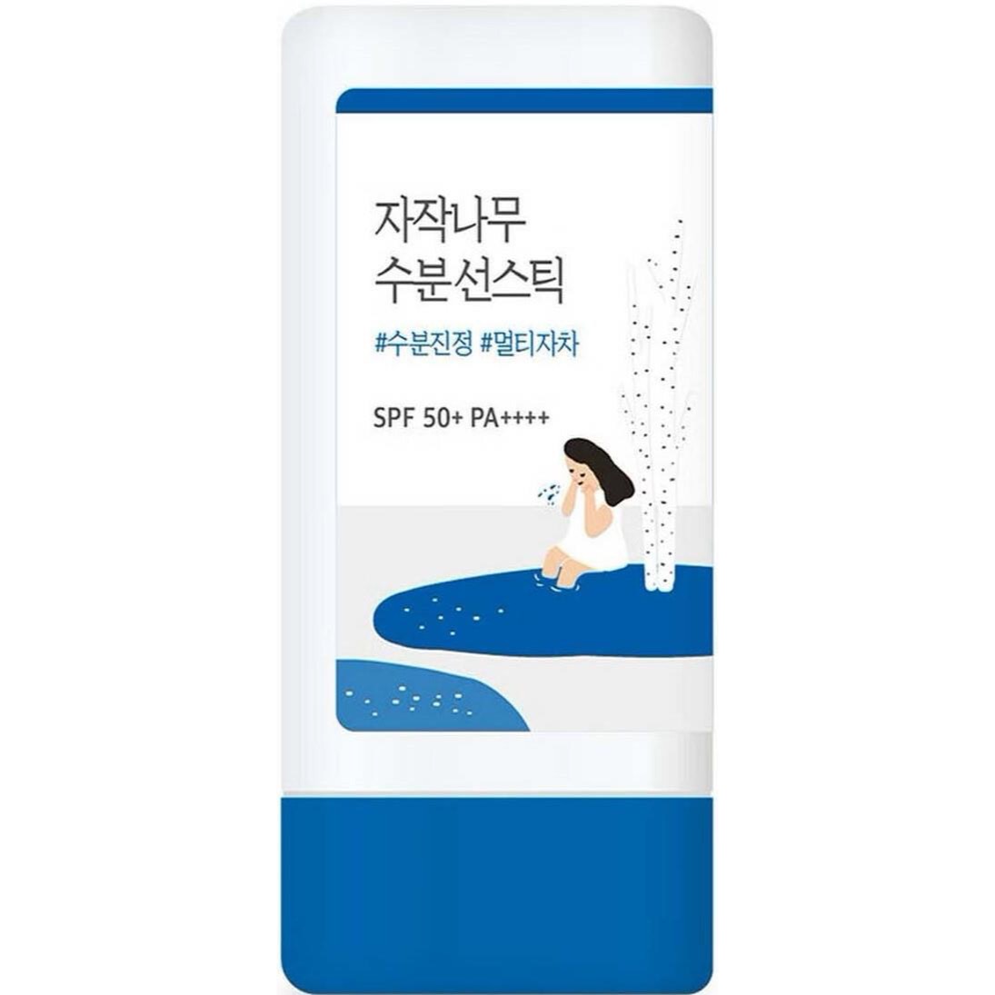Round Lab Birch Juice Moisturizing Sun Stick — omärkt solstift i twist-up-hylsa på rosa handduk i varmt ljus